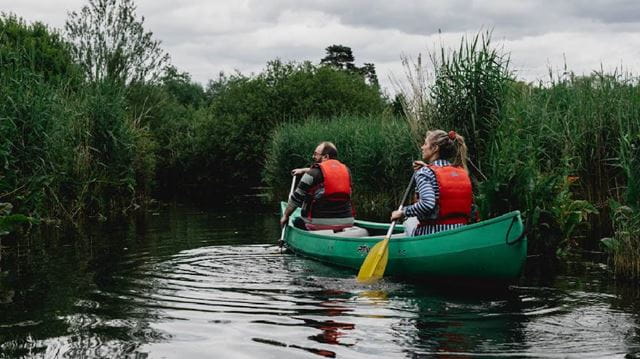 Couple kayaking in wetlands